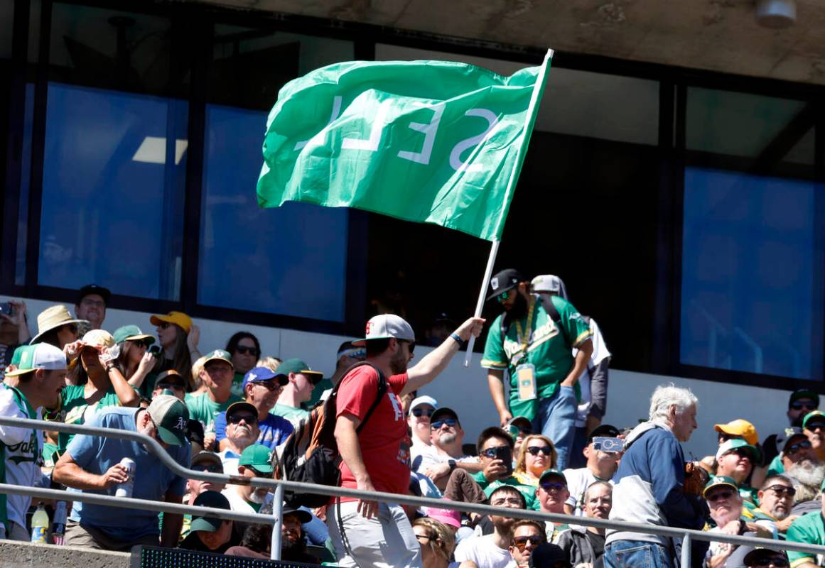 An Oakland Athletics fan waves "Sell" flag during the final home game against the Tex ...