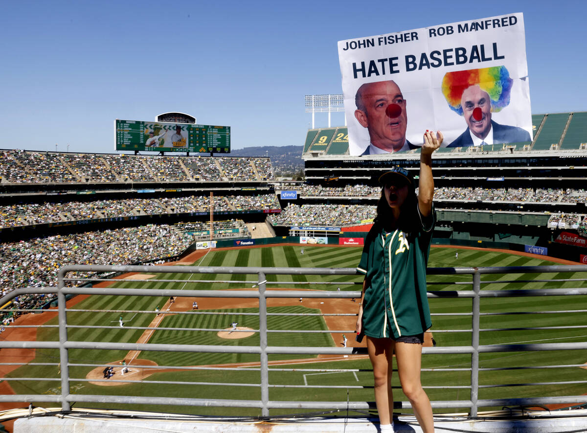 Sophia Gardea holds a sign during Oakland Athletics final home game against the Texas Rangers a ...