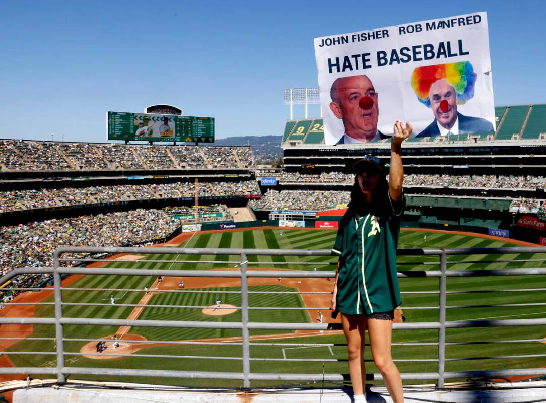 Sophia Gardea holds a sign during Oakland Athletics final home game against the Texas Rangers a ...