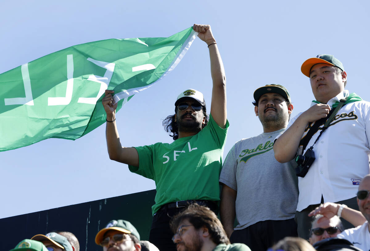 An Oakland Athletics fan waves "Sell" flag during the final home game against the Tex ...