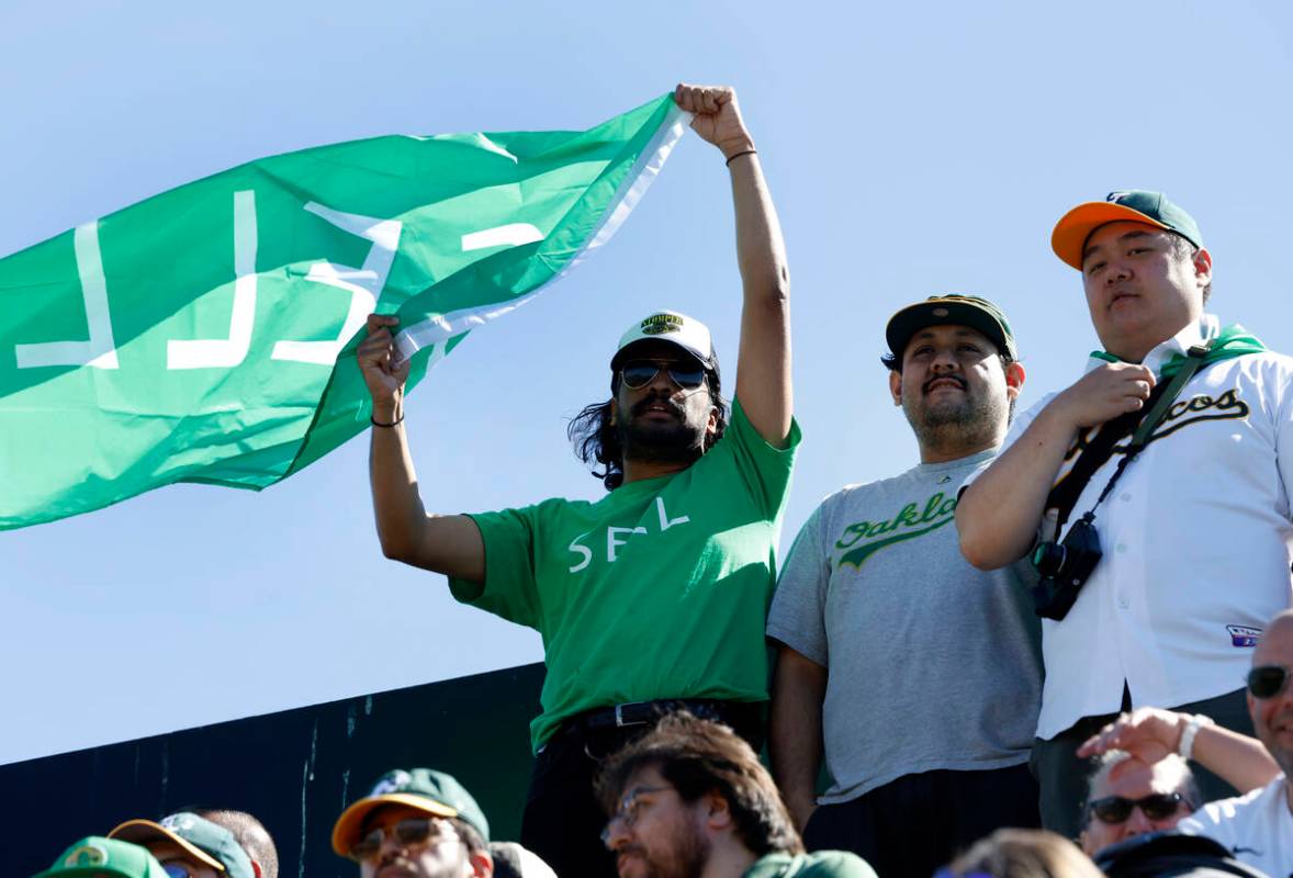 An Oakland Athletics fan waves "Sell" flag during the final home game against the Tex ...