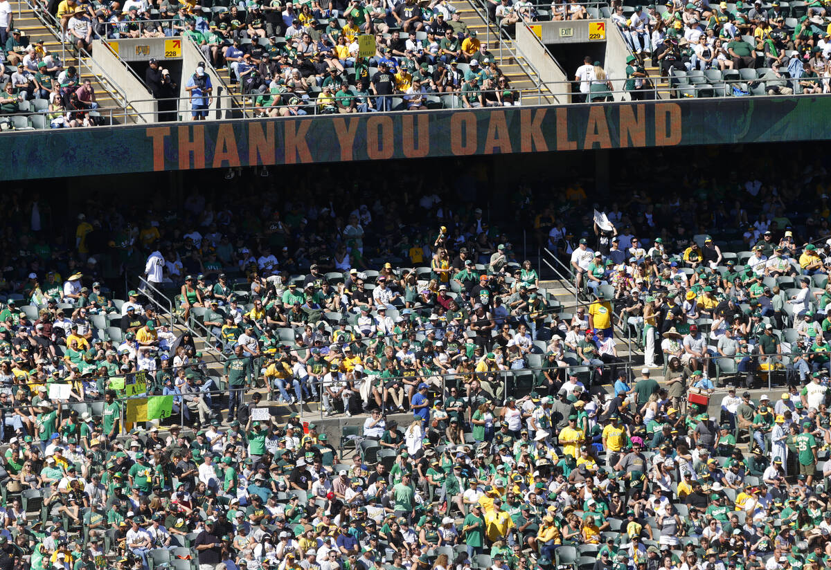 Oakland Athletics fans watch the final home game against the Texas Rangers at Oakland Coliseum, ...