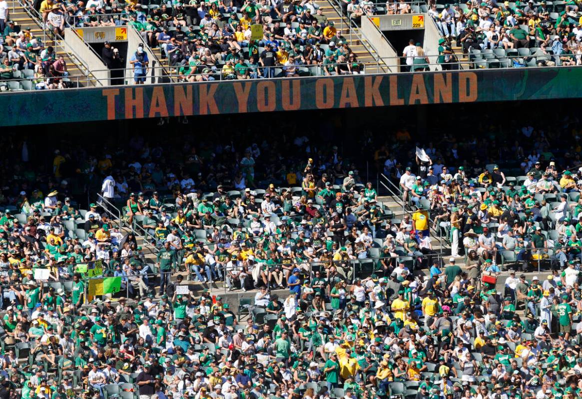 Oakland Athletics fans watch the final home game against the Texas Rangers at Oakland Coliseum, ...