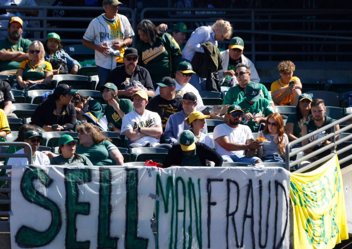 Oakland Athletics fans display signs as they watch the final home game against the Texas Ranger ...