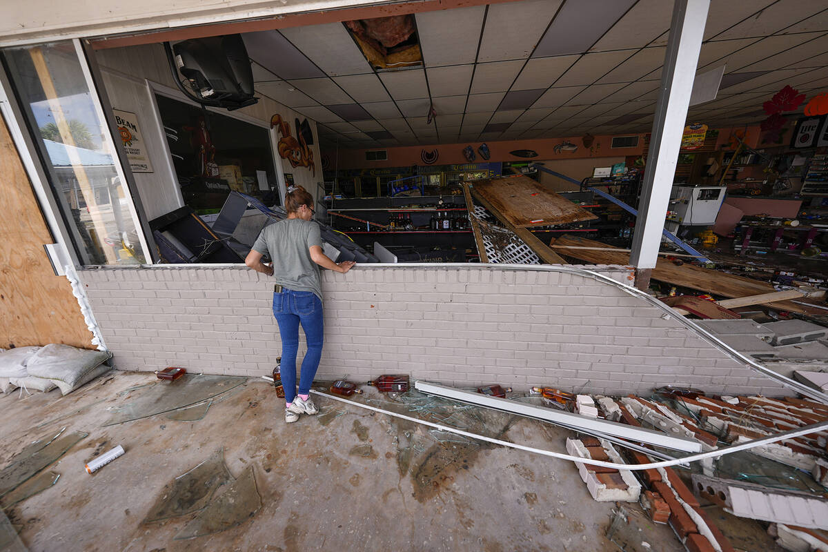 Karen Hurne surveys the damaged Swami Spirits in the aftermath of Hurricane Helene, in Cedar Ke ...