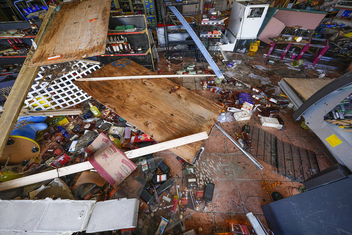 Liquor and beer bottles are seen strewn inside of Swami Spirits, in the aftermath of the storm ...