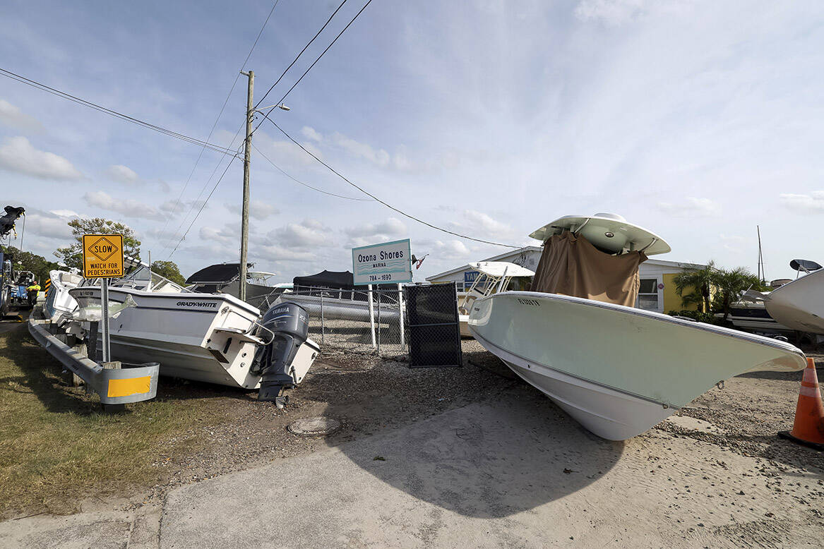 Boats sit on the drive and roadways after being pushed by floodwaters from Hurricane Helene at ...