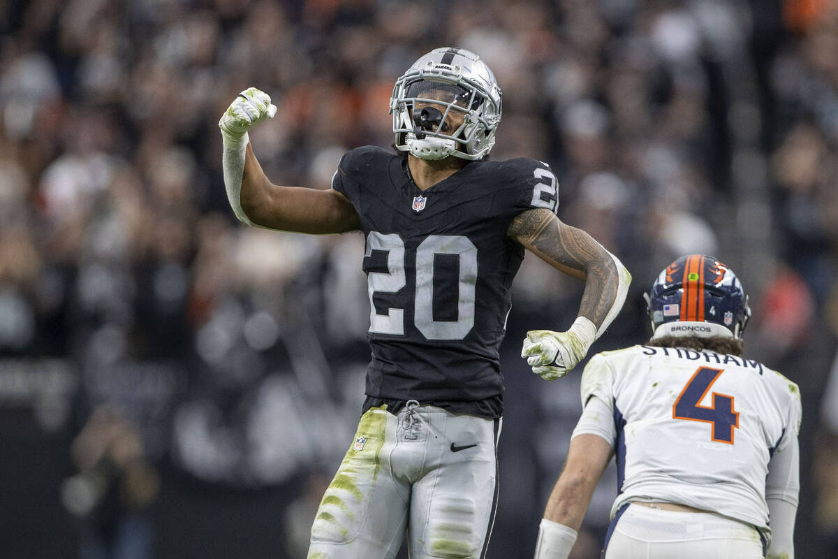 Raiders safety Isaiah Pola-Mao (20) celebrates his sack of Denver Broncos quarterback Jarrett S ...