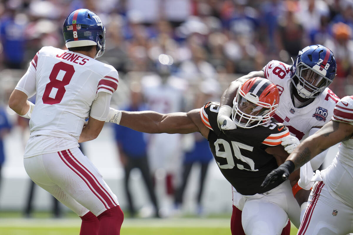 Cleveland Browns defensive end Myles Garrett (95) reaches for New York Giants quarterback Danie ...