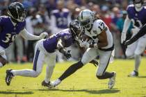 Baltimore Ravens cornerback Brandon Stephens (21) closes in to tackle Raiders wide receiver Dav ...