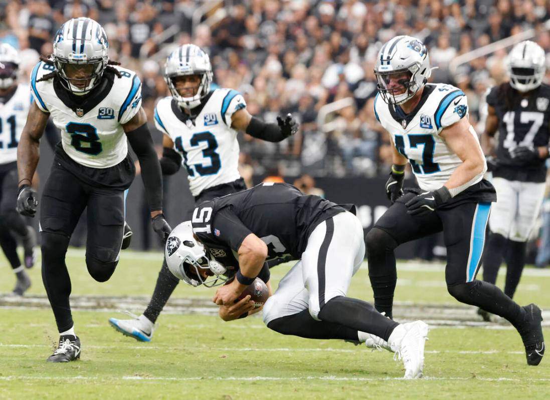 Raiders quarterback Gardner Minshew (15) stumbles as he runs with ball against Carolina Panther ...