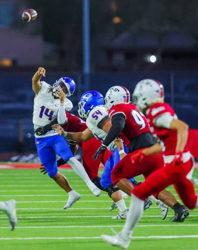 Bishop Gorman quarterback Maika Eugenio (14) is sacked after a throw during a high school footb ...