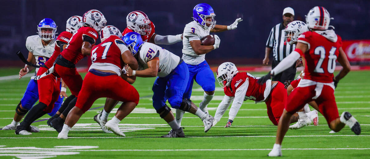 Bishop Gorman running back Terrance Grant (3) scrambles to free himself from Liberty defense du ...