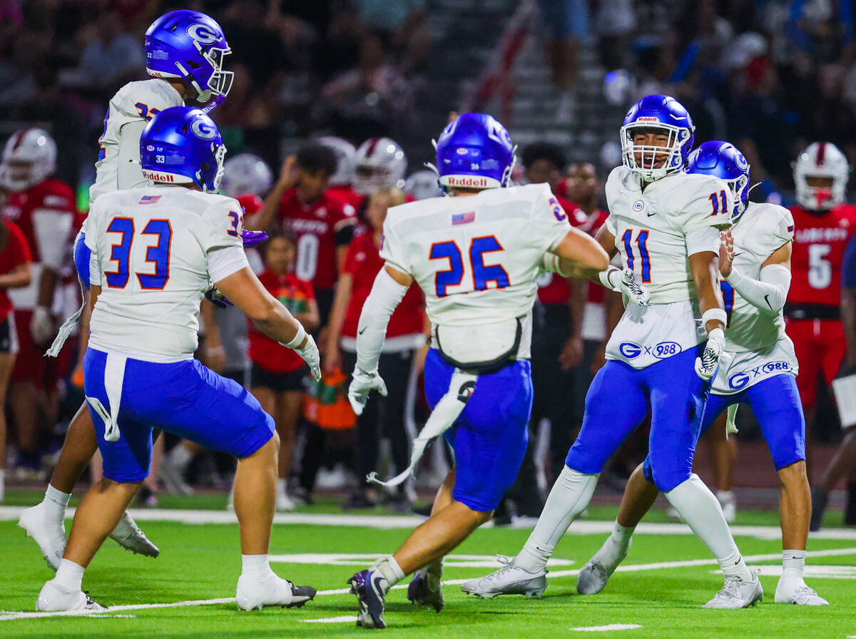 Bishop Gorman players celebrate during a high school football game between Bishop Gorman and Li ...