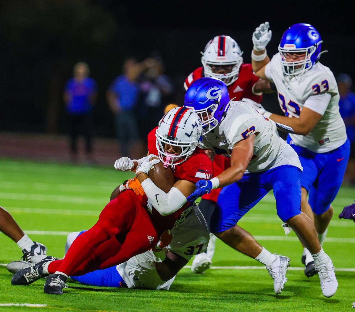 Liberty running back Ezra Sanelivi (1) runs the ball through Bishop Gorman defense during a hig ...