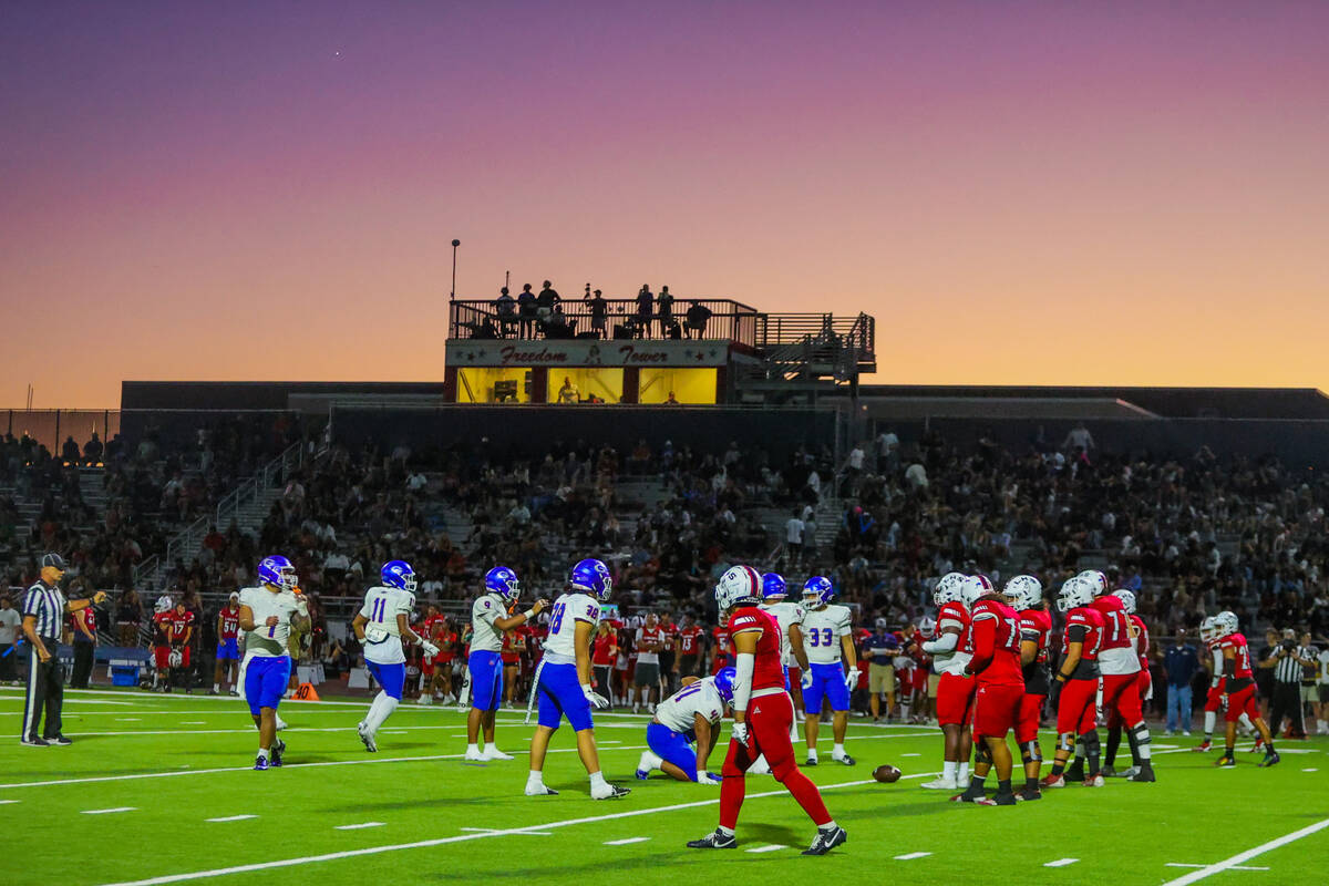 The sun sets during a high school football game between Bishop Gorman and Liberty at Liberty Hi ...