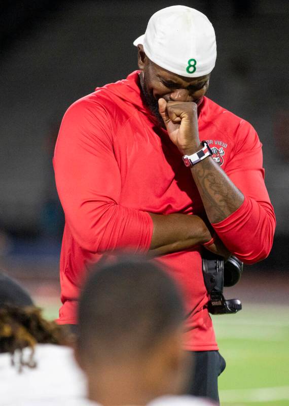 Arbor View Head Coach Marlon Barnett becomes emotional while talking to his football team after ...