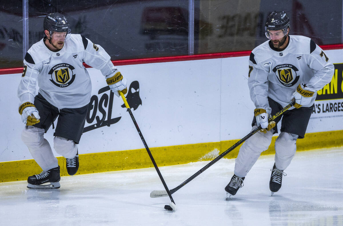 Golden Knights center Jack Eichel (9) advances the puck beside defenseman Alex Pietrangelo (7) ...