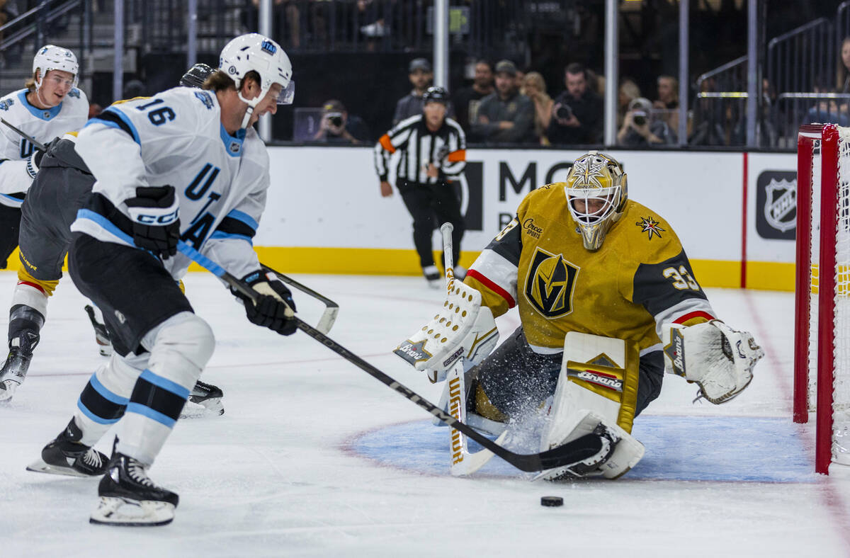 Golden Knights goaltender Adin Hill (33) looks to stop a shot by Utah Hockey Club forward Ryan ...