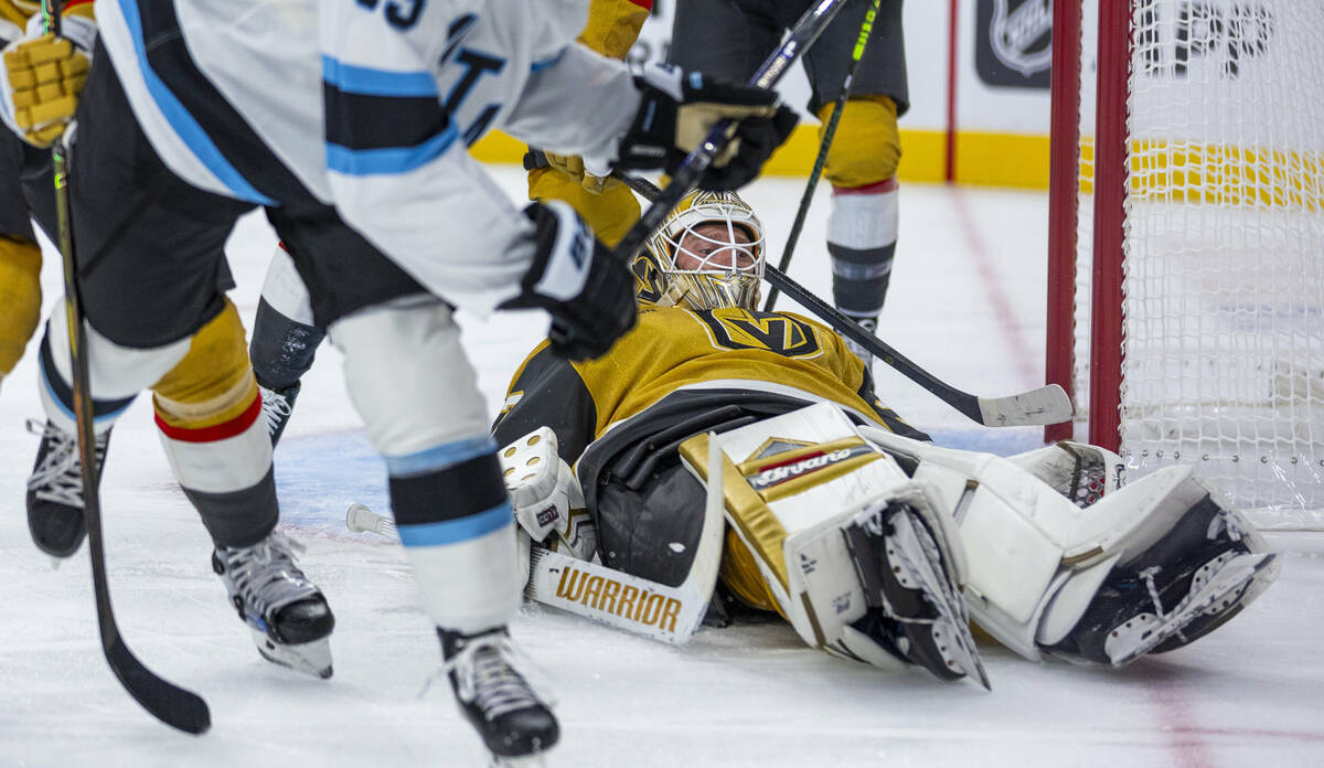 Golden Knights goaltender Adin Hill (33) looks up after a stop on a shot by Utah Hockey Club fo ...