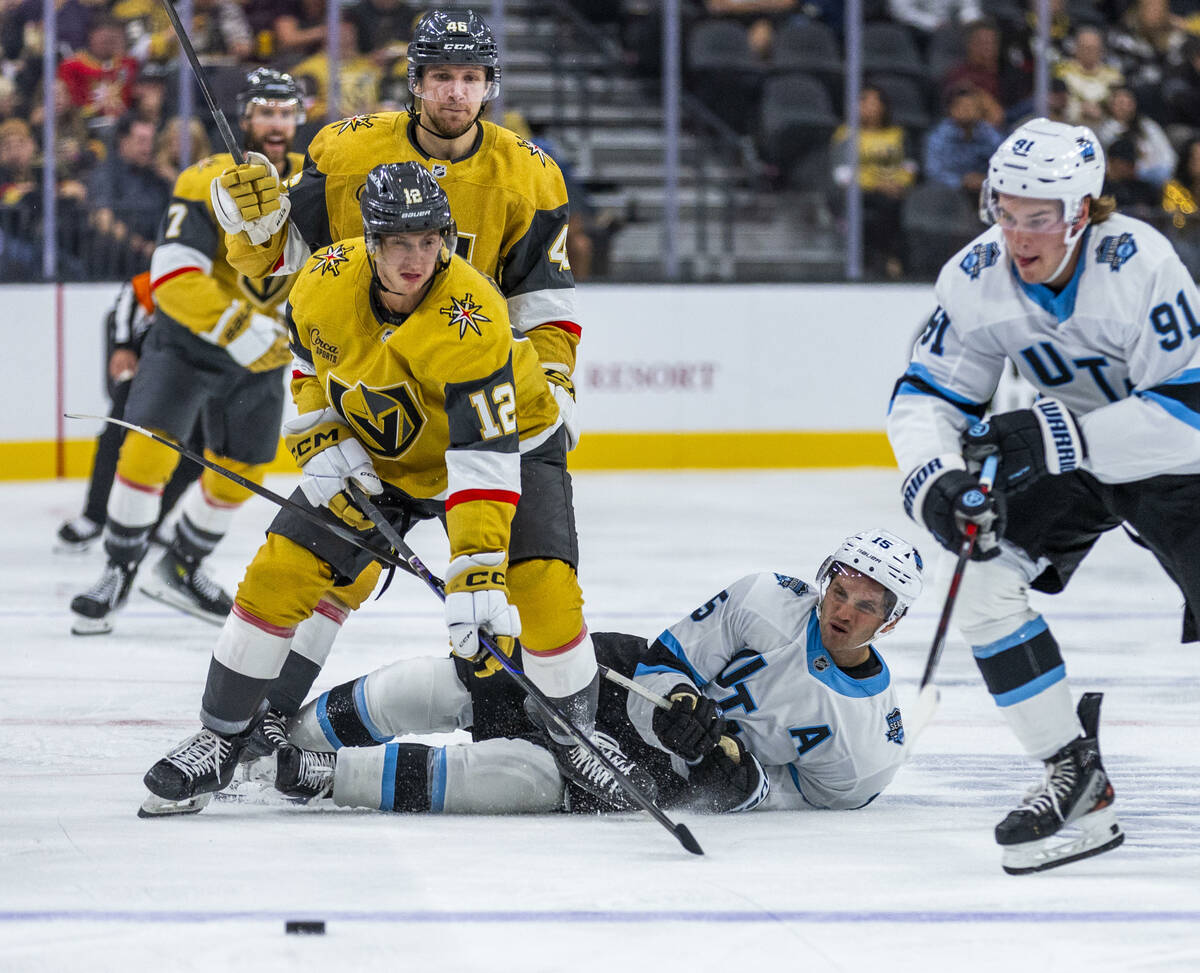 Golden Knights center Jakub Brabenec (12) eyes the puck as Utah Hockey Club forward Alex Kerfoo ...