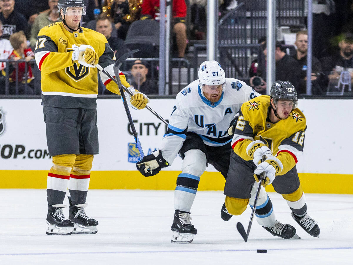 Golden Knights center Jakub Brabenec (12) is takes down from behind by Utah Hockey Club forward ...