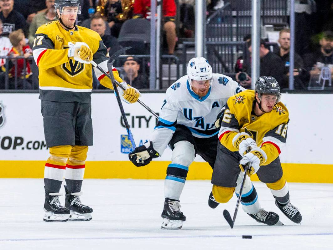 Golden Knights center Jakub Brabenec (12) is takes down from behind by Utah Hockey Club forward ...