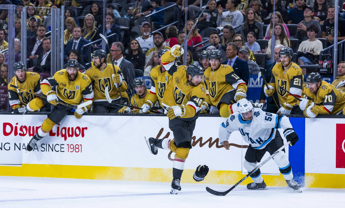 Golden Knights center Tomas Hertl (48) evades a check by Utah Hockey Club defenseman Sean Durzi ...