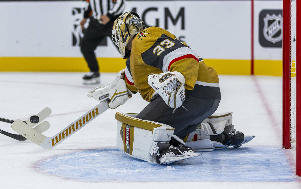 Golden Knights goaltender Adin Hill (33) deflects a shot by the Utah Hockey Club during the thi ...