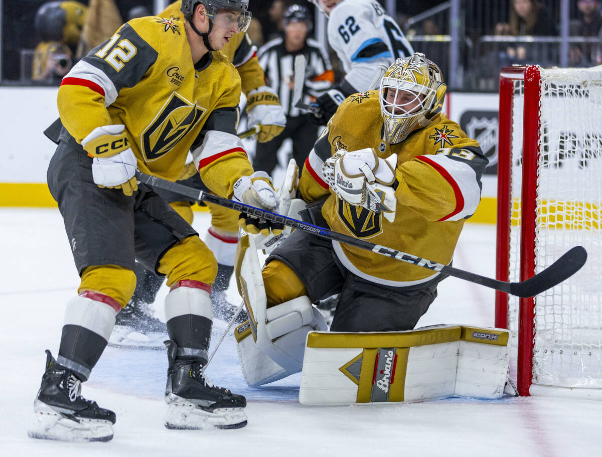 Golden Knights goaltender Adin Hill (33) snags a shot by the Utah Hockey Club with Golden Knigh ...