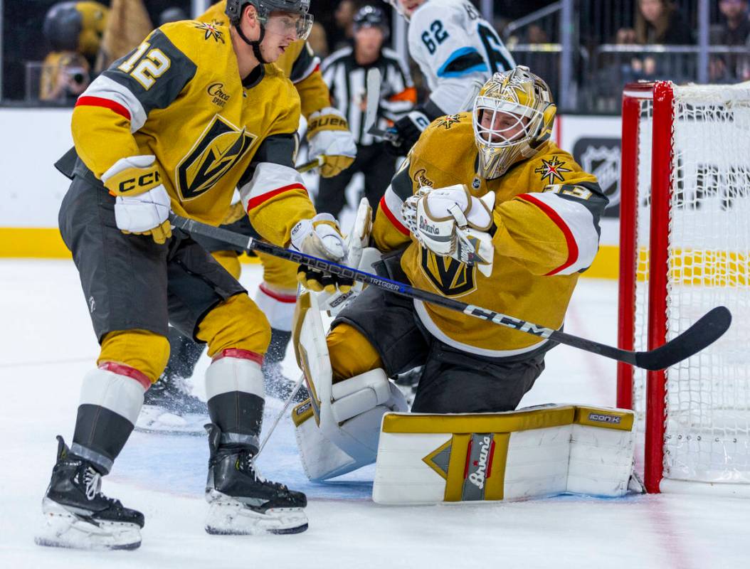 Golden Knights goaltender Adin Hill (33) snags a shot by the Utah Hockey Club with Golden Knigh ...