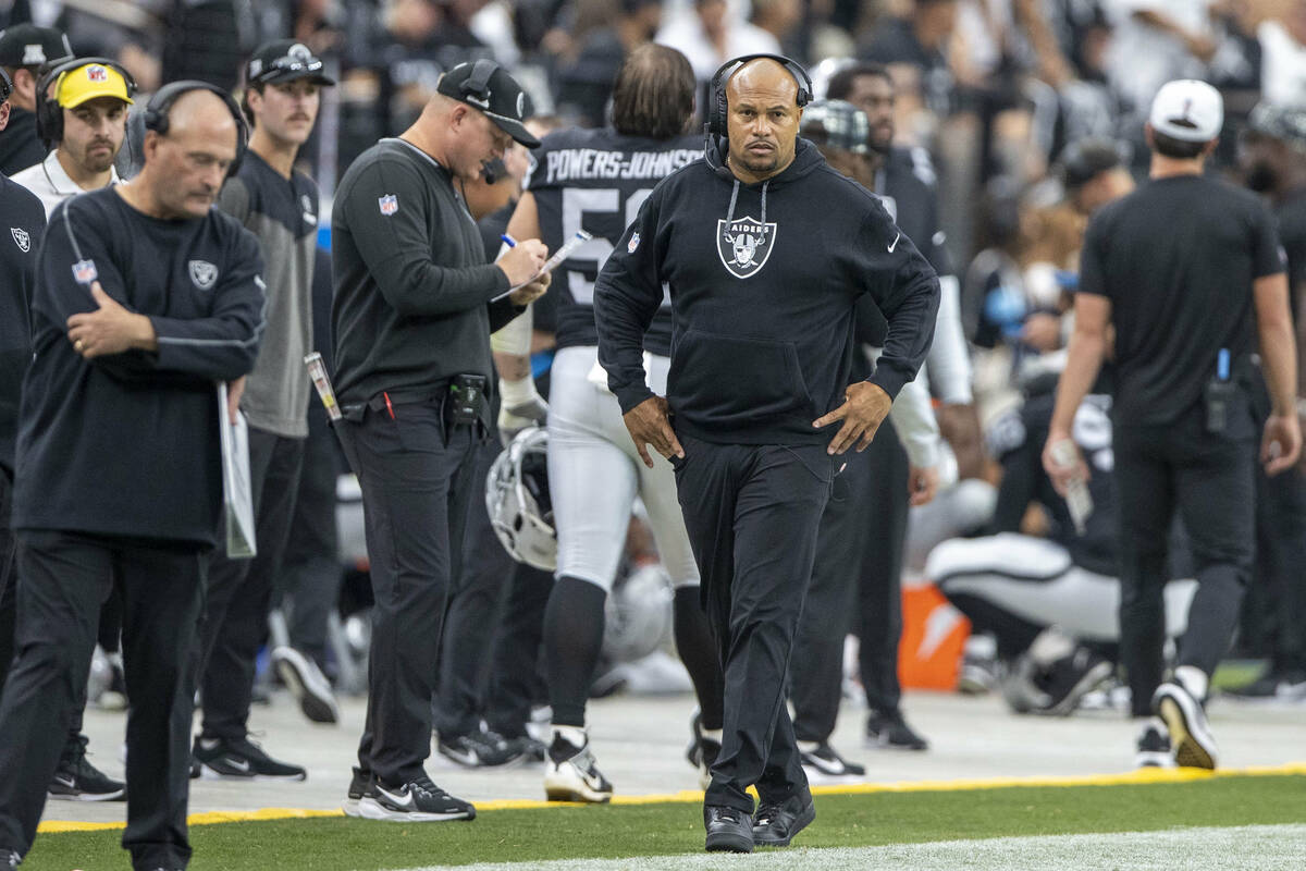 Raiders head coach Antonio Pierce walks the sideline during the second half of an NFL game agai ...