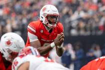 UNLV quarterback Hajj-Malik Williams (6) prepares to snap the ball during the college football ...