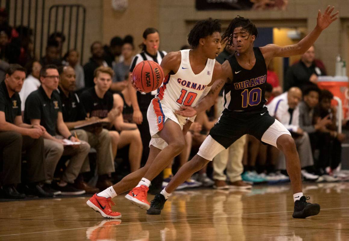 Bishop Gorman's Zaon Collins (10) dribbles past Durango's Keshon Gilbert (10) at Desert Oasis H ...