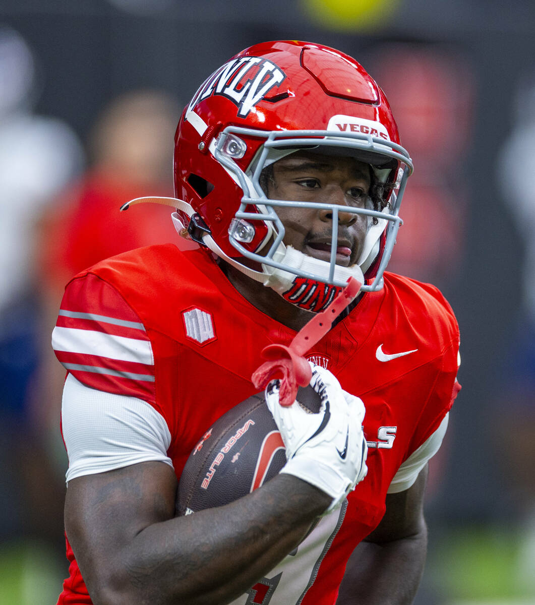 UNLV running back Jai'Den Thomas (9) runs with the ball during warm ups of their NCAA football ...