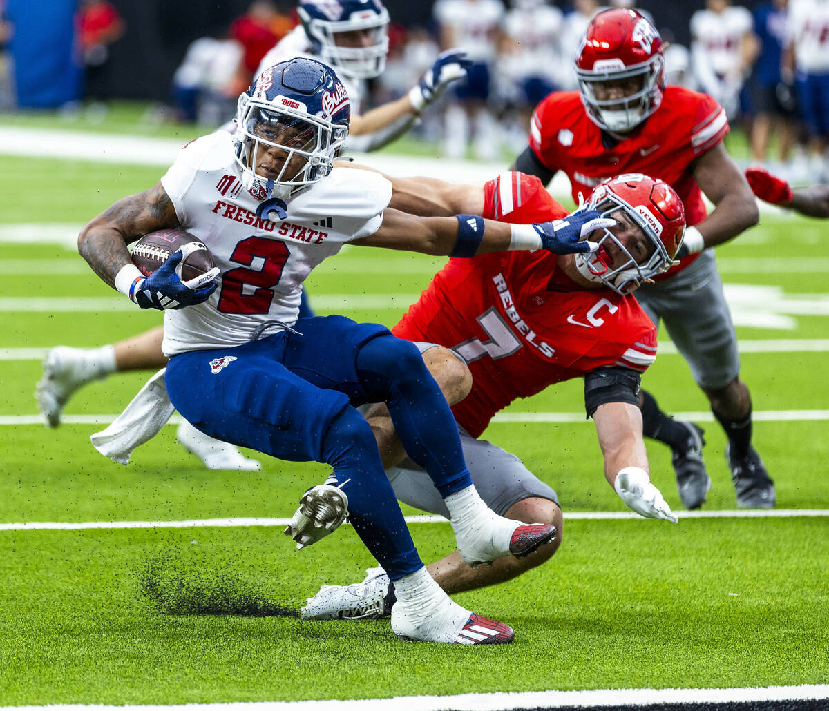 Fresno State running back Malik Sherrod (2) barely escapes a safety as UNLV linebacker Jackson ...