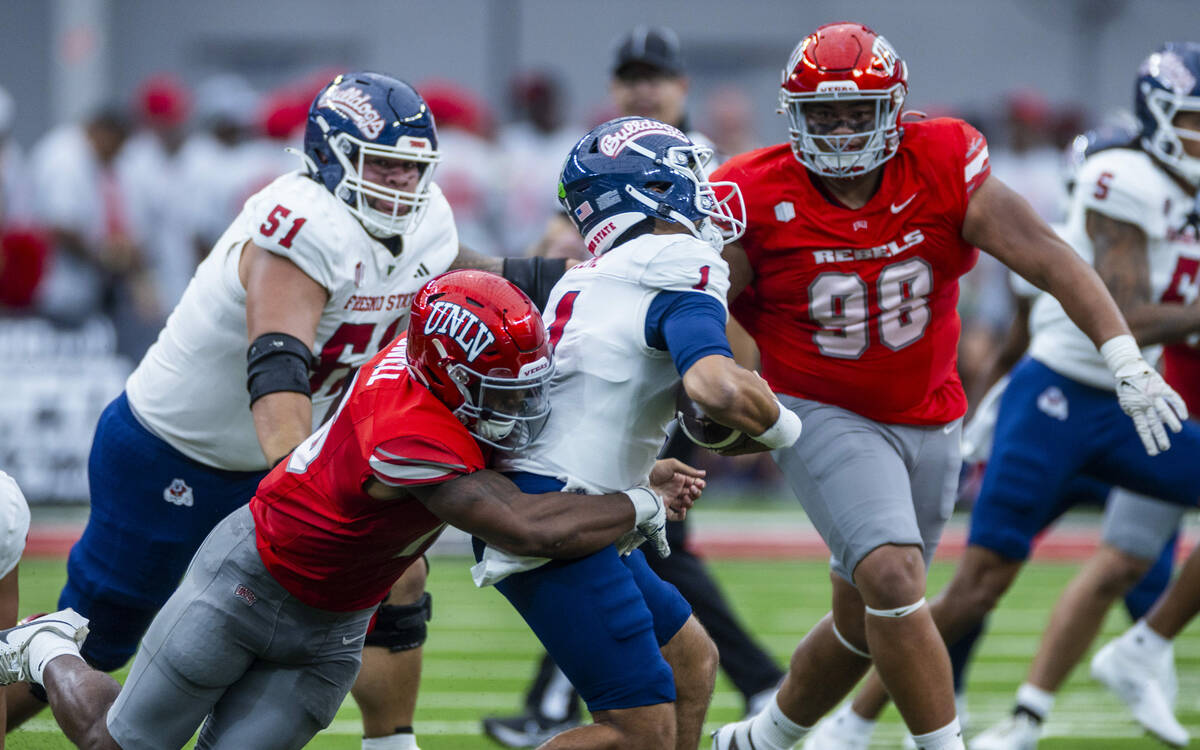 UNLV linebacker Mani Powell (16) takes down sacks Fresno State Bulldogs quarterback Mikey Keene ...