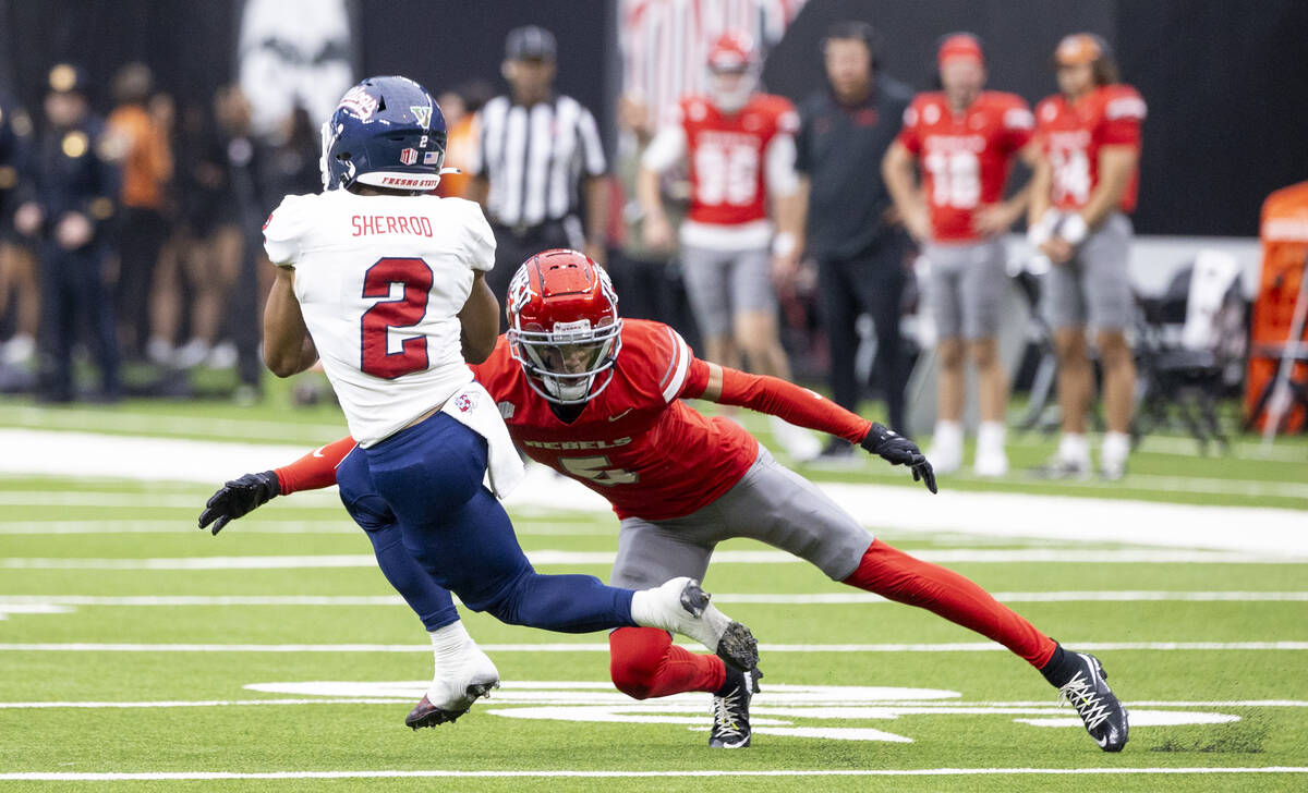 UNLV defensive back Cameron Oliver (5) attempts to tackle Fresno State running back Malik Sherr ...