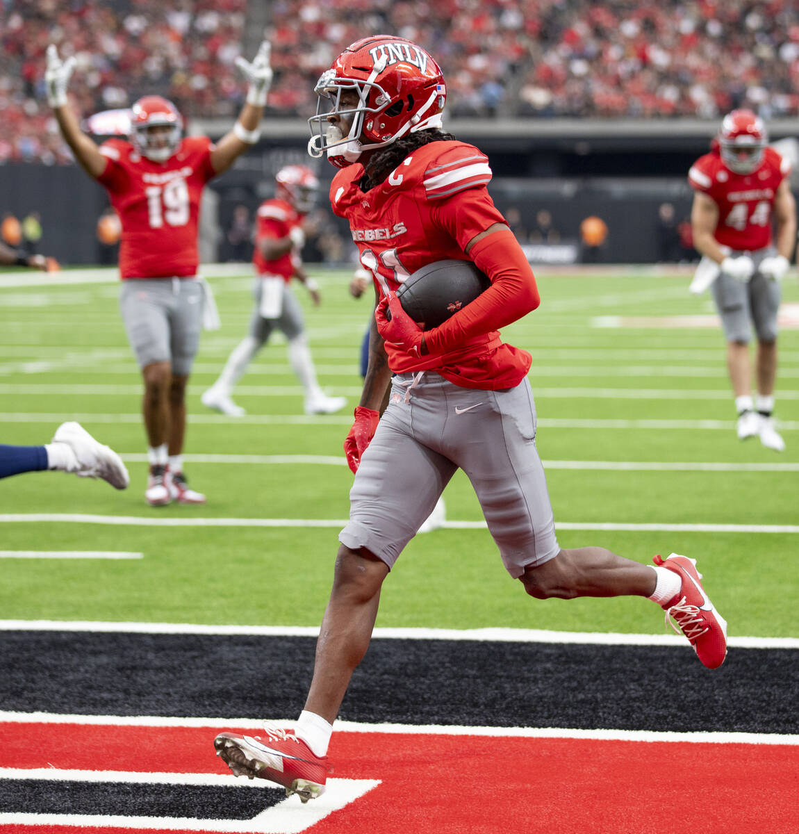 UNLV wide receiver Ricky White III (11) scores a touchdown during the college football game aga ...