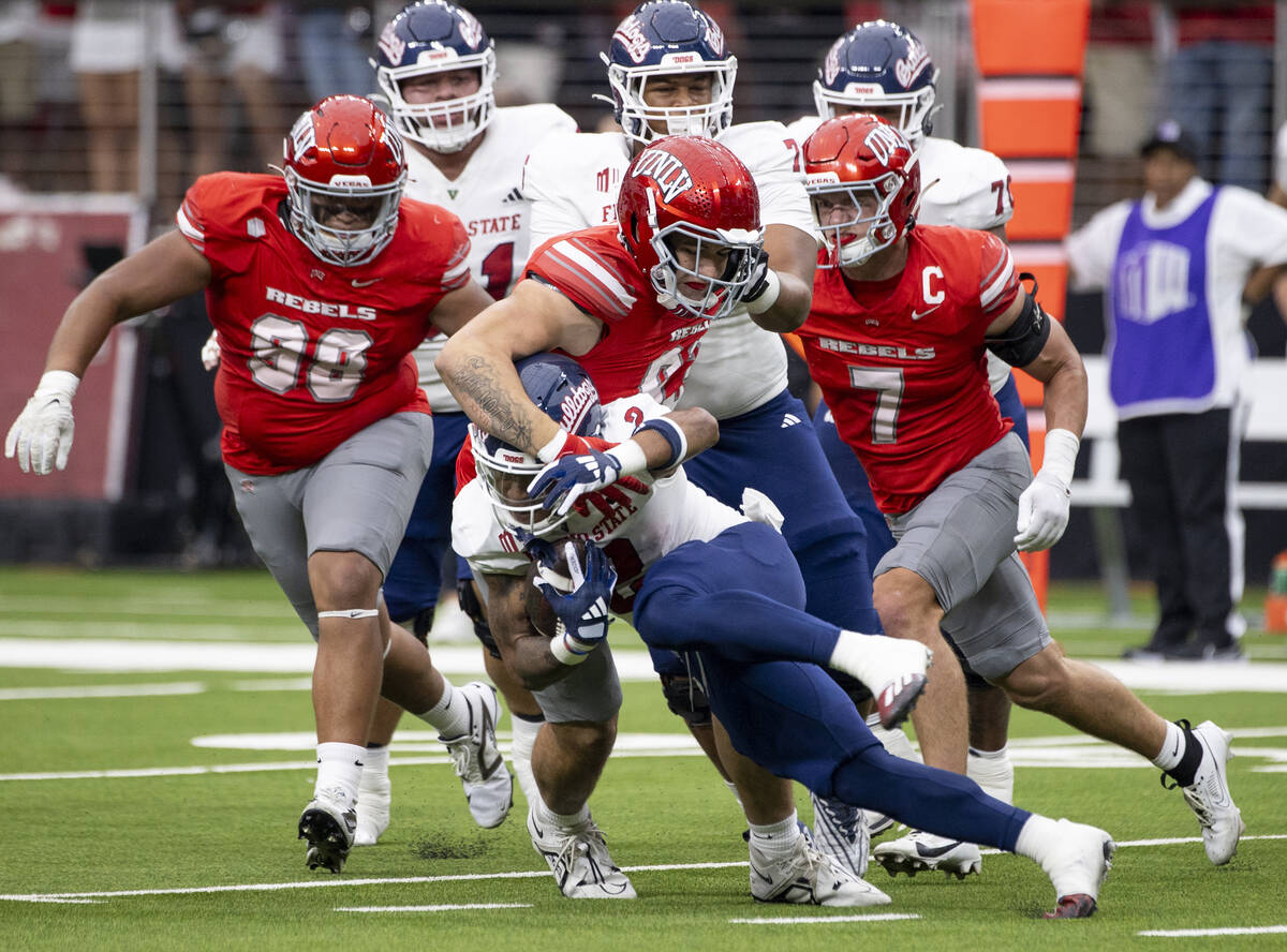 UNLV defensive lineman Lucas Conti (93) wraps up Fresno State running back Malik Sherrod (2) du ...