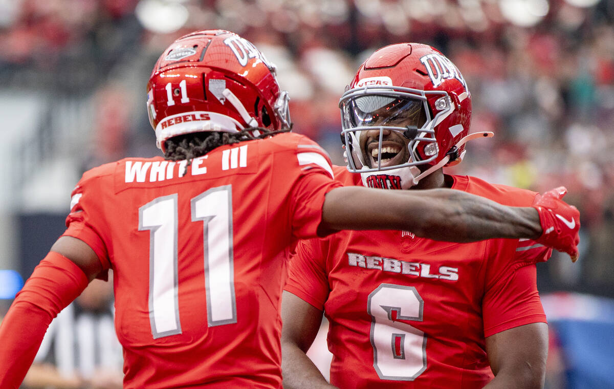 UNLV quarterback Hajj-Malik Williams (6) celebrates with wide receiver Ricky White III (11) aft ...