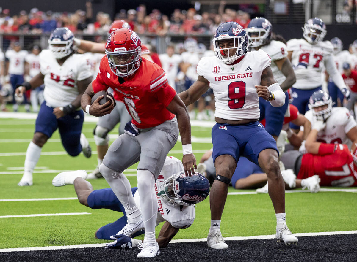 UNLV quarterback Hajj-Malik Williams (6) scores a touchdown during the college football game ag ...