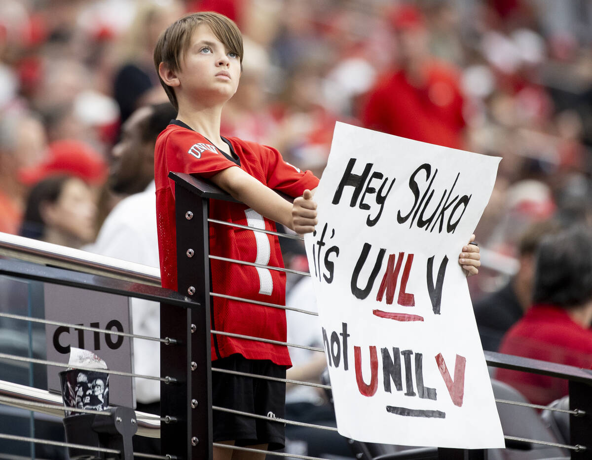 A young UNLV fan holds a sign before the college football game against Fresno State at Allegian ...