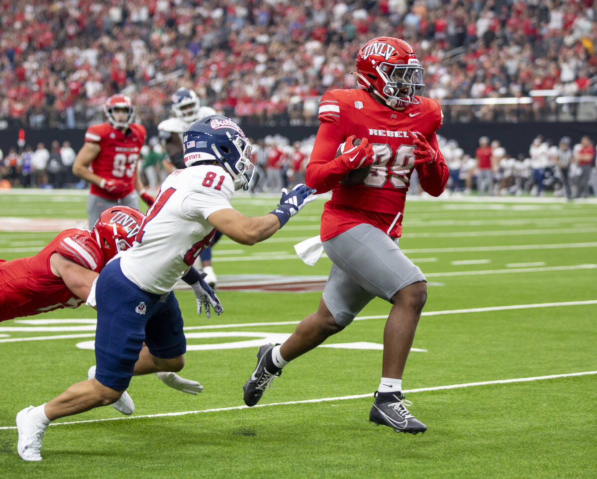 UNLV defensive lineman Keith Conley Jr. (99) runs toward the end zone after scooping up a block ...