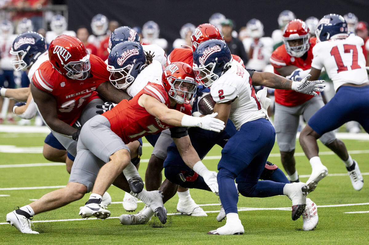 UNLV linebacker Jackson Woodard (7) tackles Fresno State running back Malik Sherrod (2) during ...