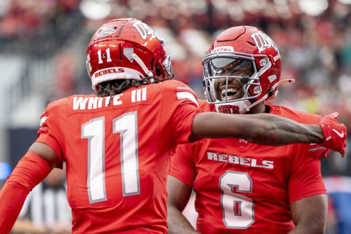 UNLV quarterback Hajj-Malik Williams (6) celebrates with wide receiver Ricky White III (11) aft ...