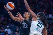 Aces center A'ja Wilson (22) gets under the defense of New York Liberty forward Jonquel Jones ( ...