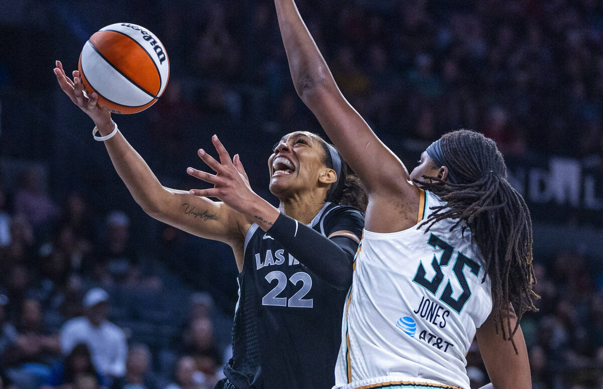 Aces center A'ja Wilson (22) gets under the defense of New York Liberty forward Jonquel Jones ( ...