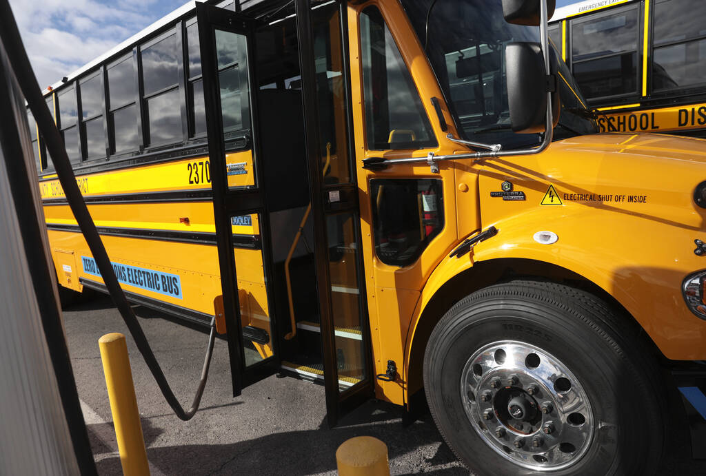 FILE - An electric school bus acquired by the Clark County School District charges at the Arvil ...