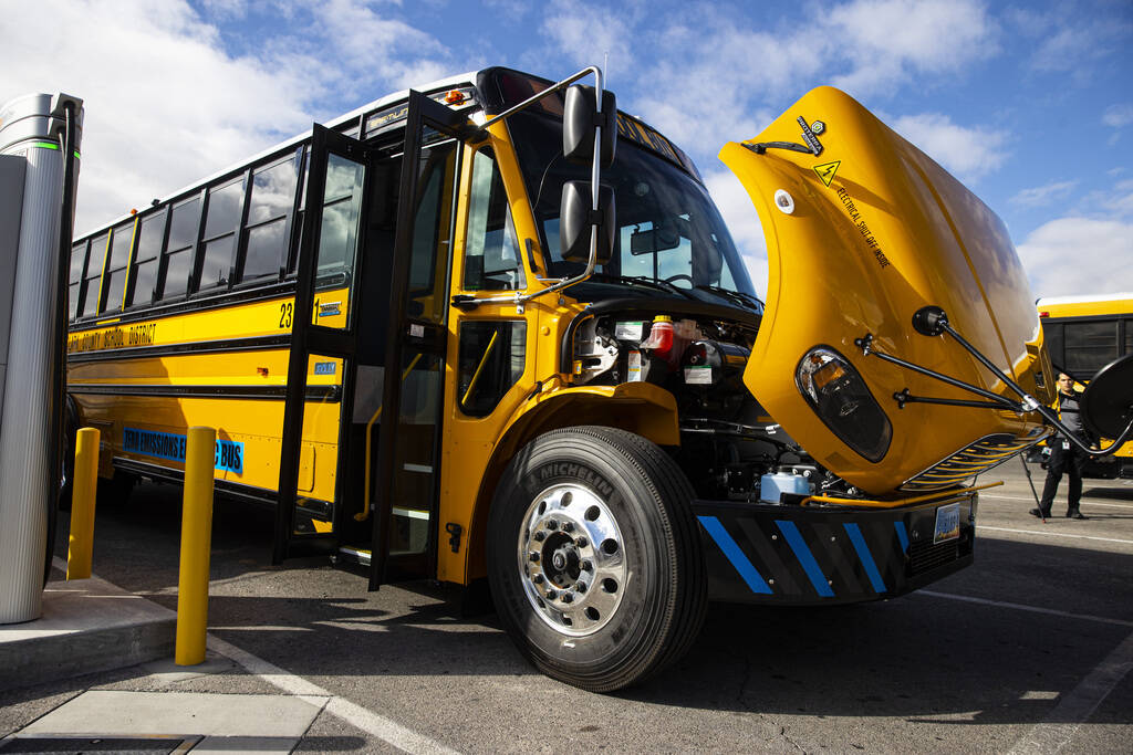 FILE - An electric school bus acquired by the Clark County School District charges at the Arvil ...